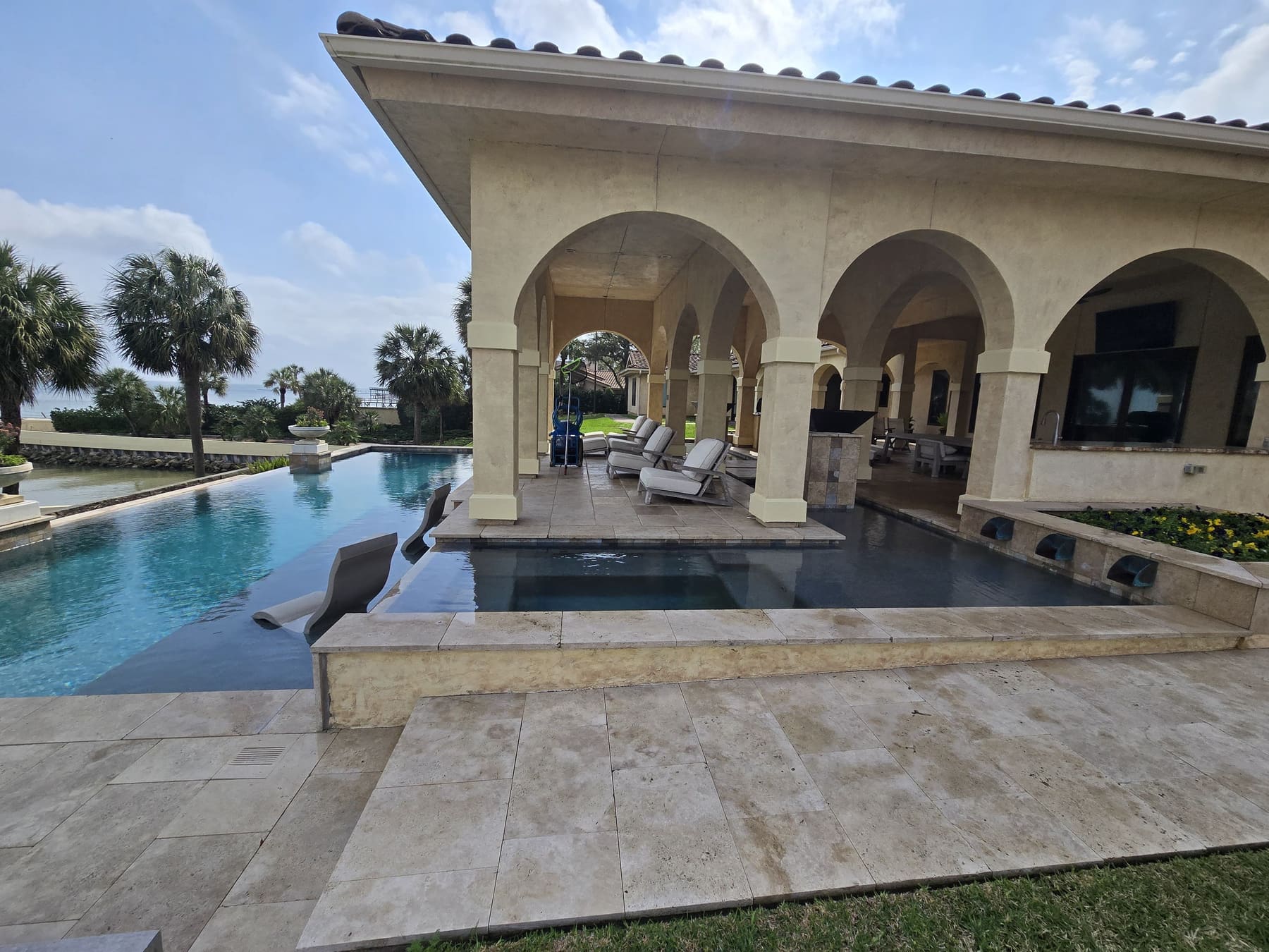 Waterfront infinity pool serviced by Pelagic Pools