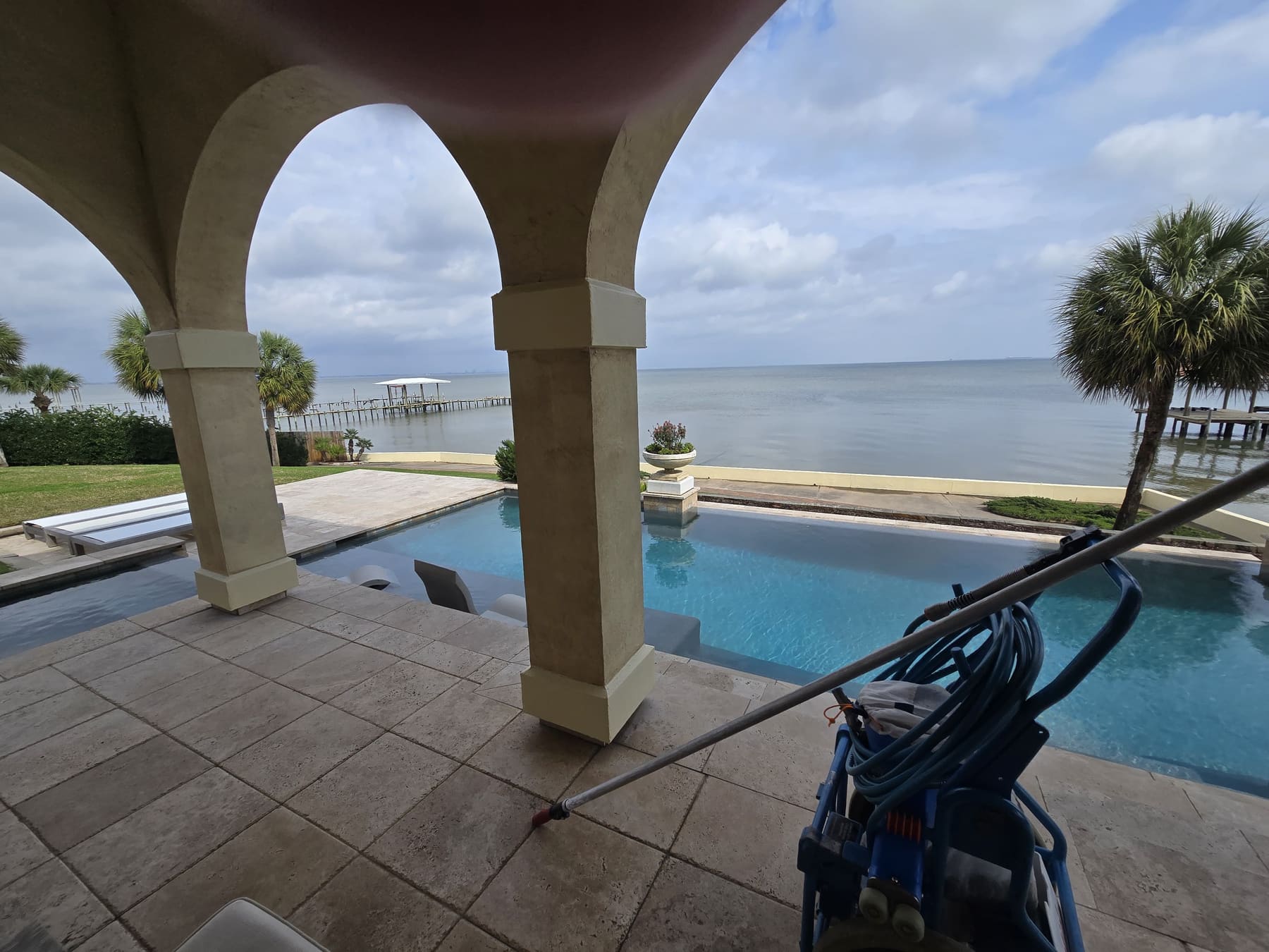 Pelagic Pools cleaning cart and vacuum pole at a bayfront pool