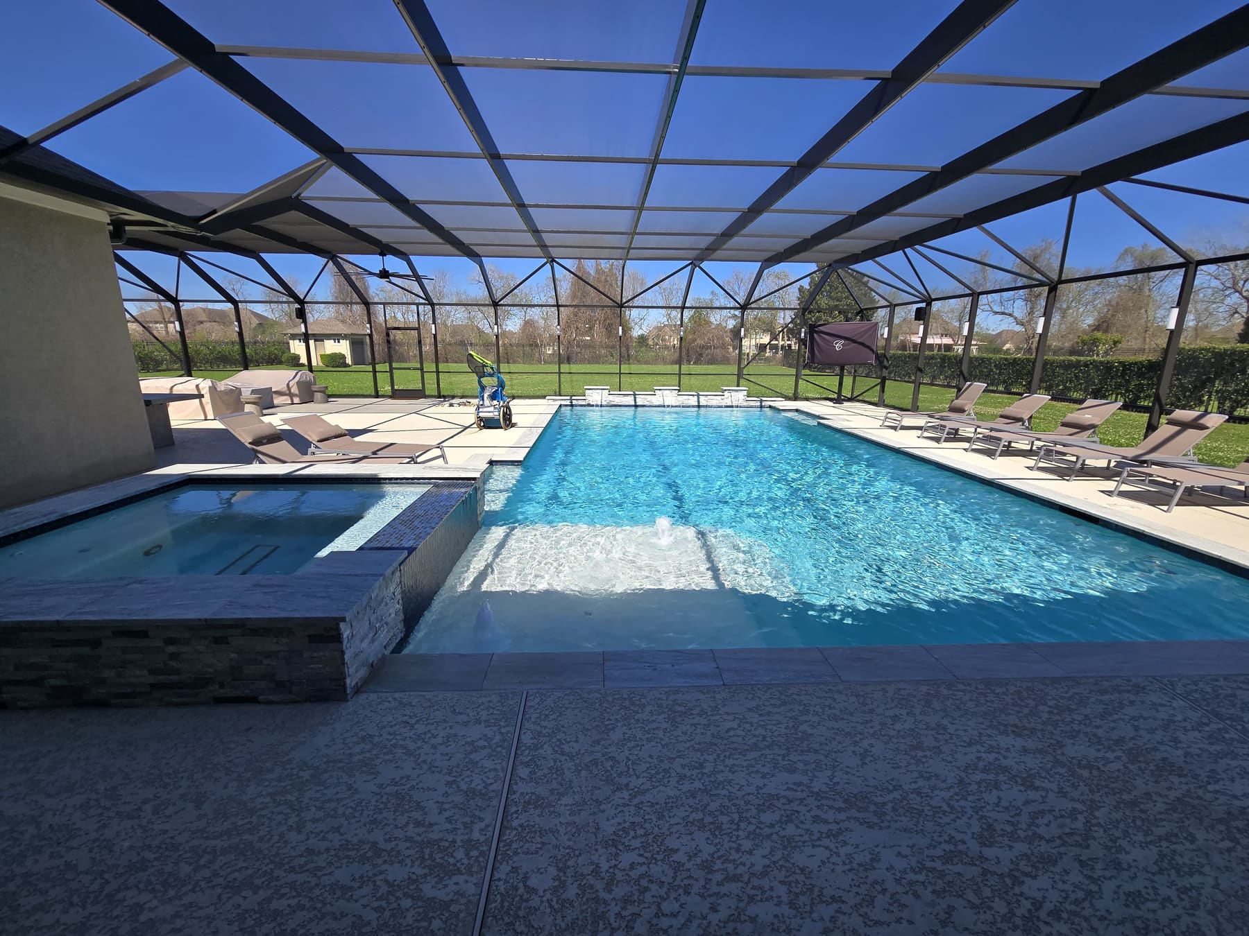 Screened-in pool and spa with a steady water line